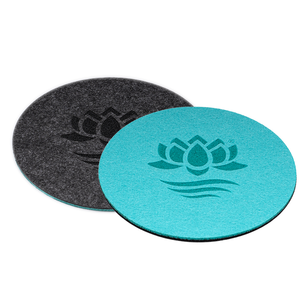 Zweifarbiger Filzuntersetzer, der die türkise und die anthrazitfarbene Seite mit dem Lotus Vita Logo zeigt.